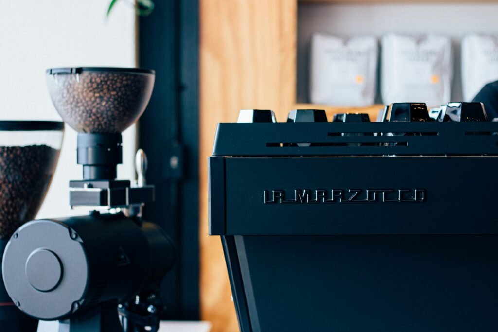 a coffee machine sitting next to a potted plant a coffee machine sitting next to a potted plant