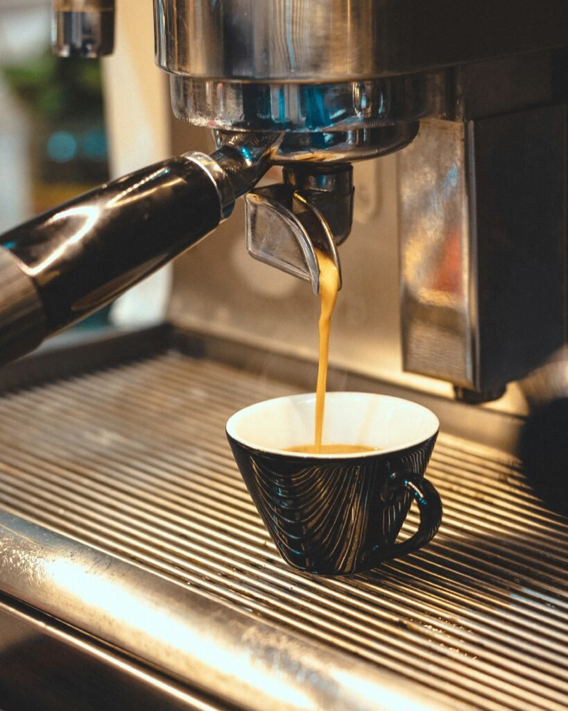 a cup of coffee being poured into a coffee machine barista pro tips